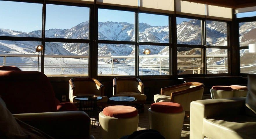 A lounge with floor-to-ceiling windows onto the slopes
